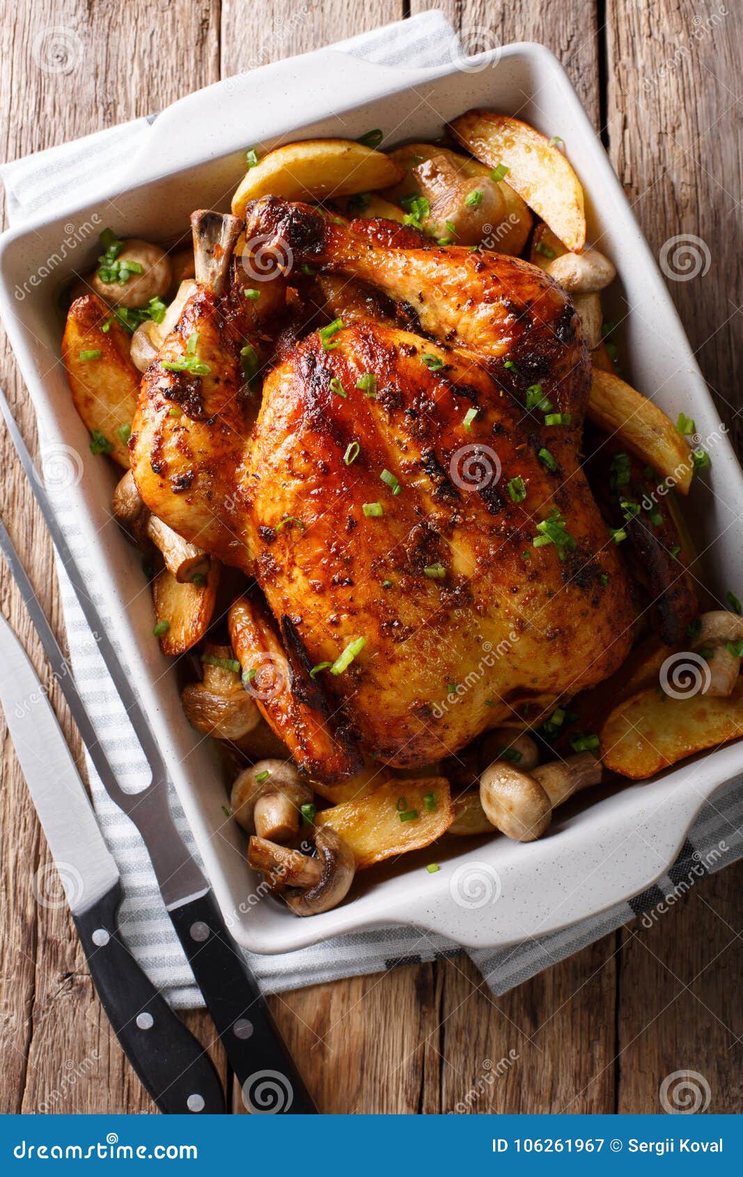 Whole Baked Chicken with Mushrooms and Potatoes Closeup in a Ba Image