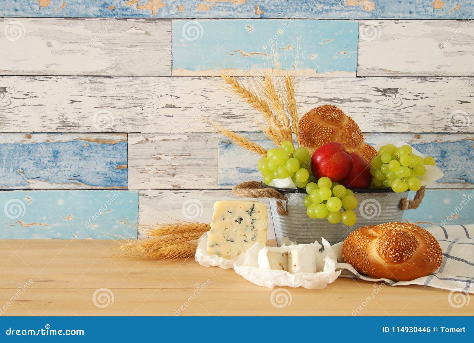 image of fruits in the tin basket over wooden table.