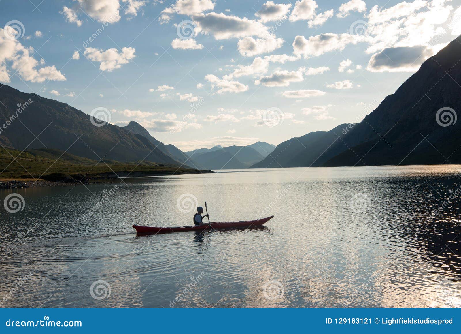 JOTUNHEIMEN NATIONAL PARK NORWAY - 27 JULY 2018: man kayaking at Gjende lake Besseggen ridge Jotunheimen National Park Norway