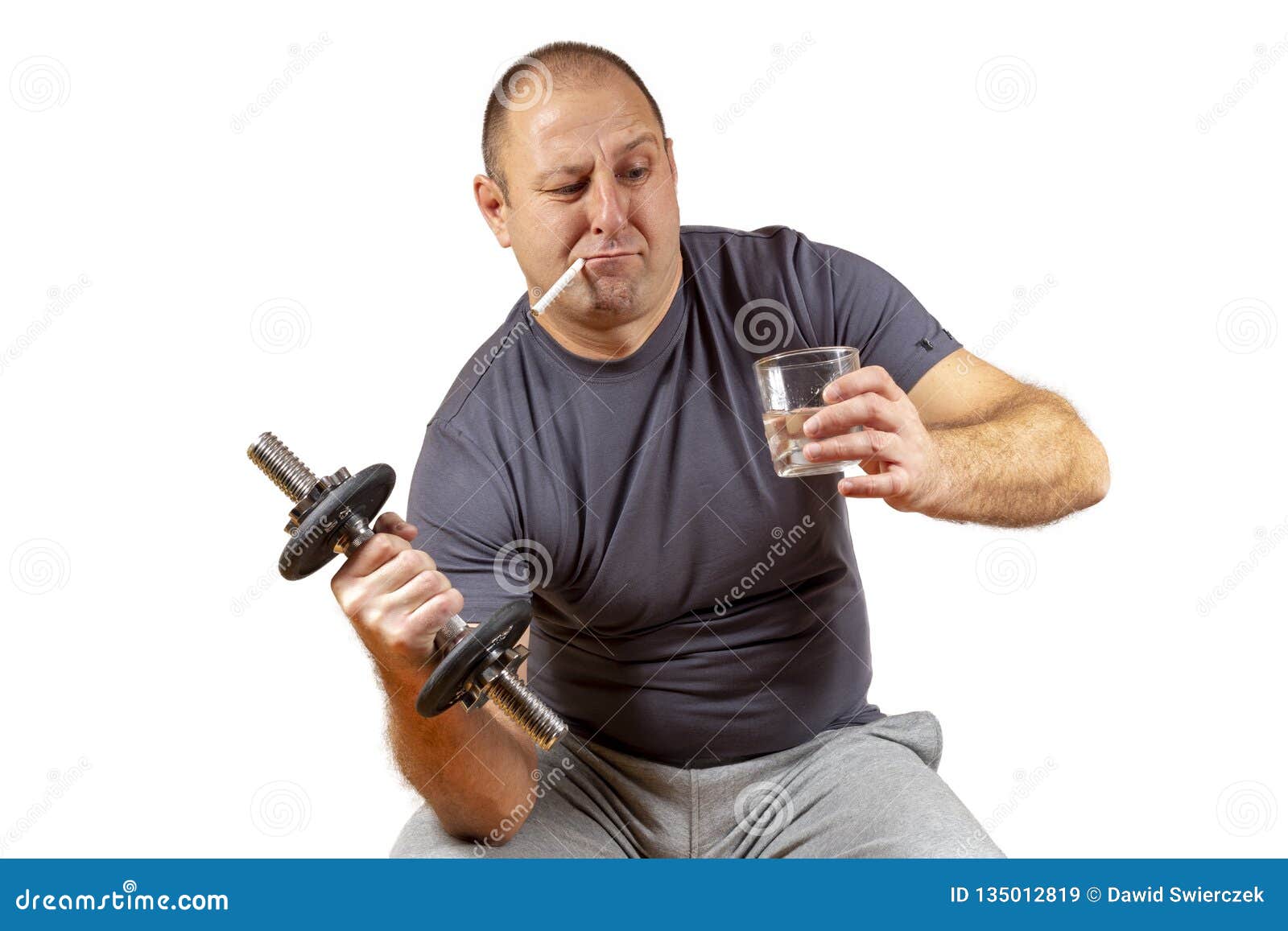 Being fit vs bad haabits. Conceptual shot of a middle aged white male trying to work you while enjoying an alcoholic drink