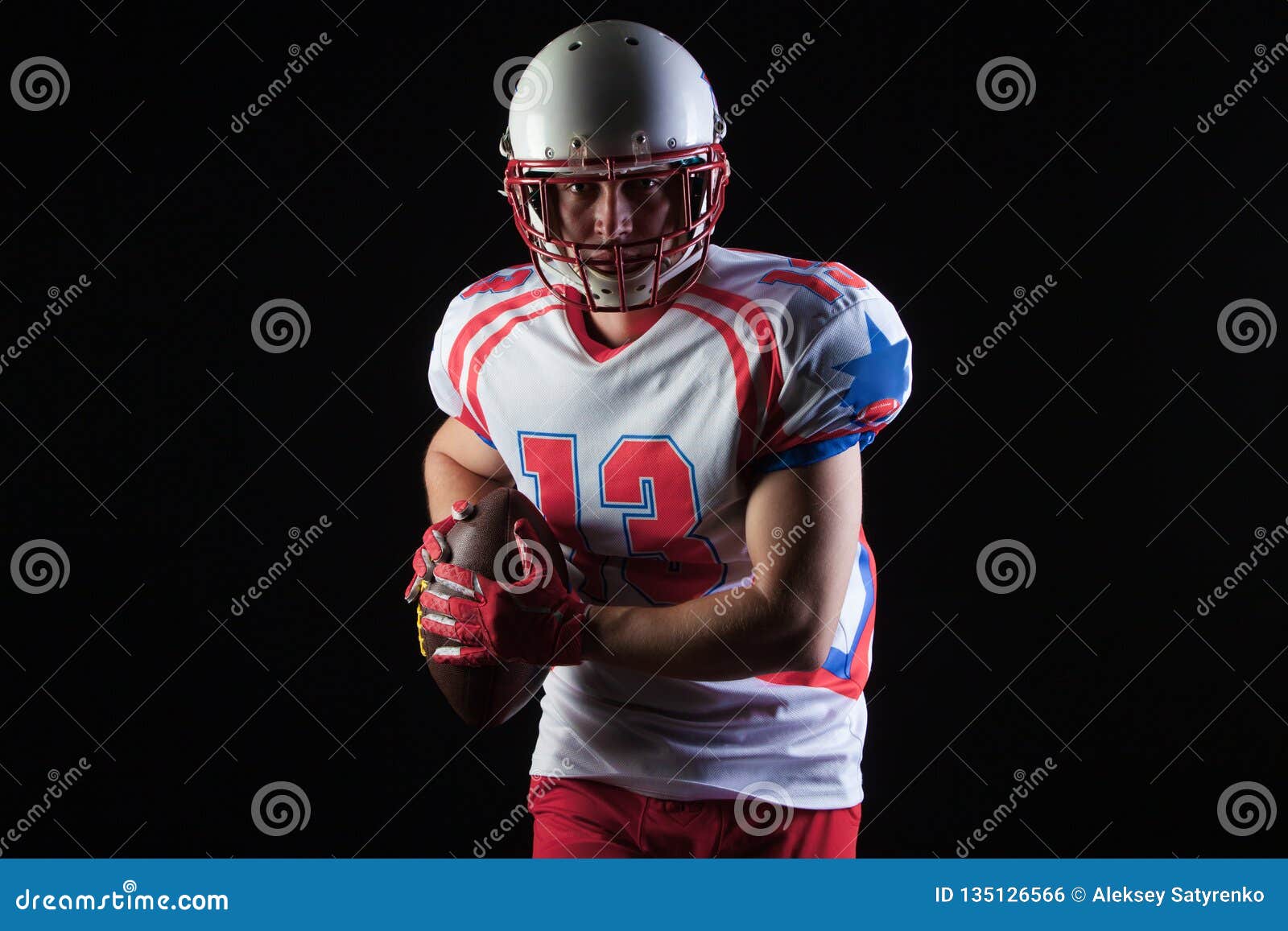 American Football Player Wearing Helmet Ready To Throw Ball on Black