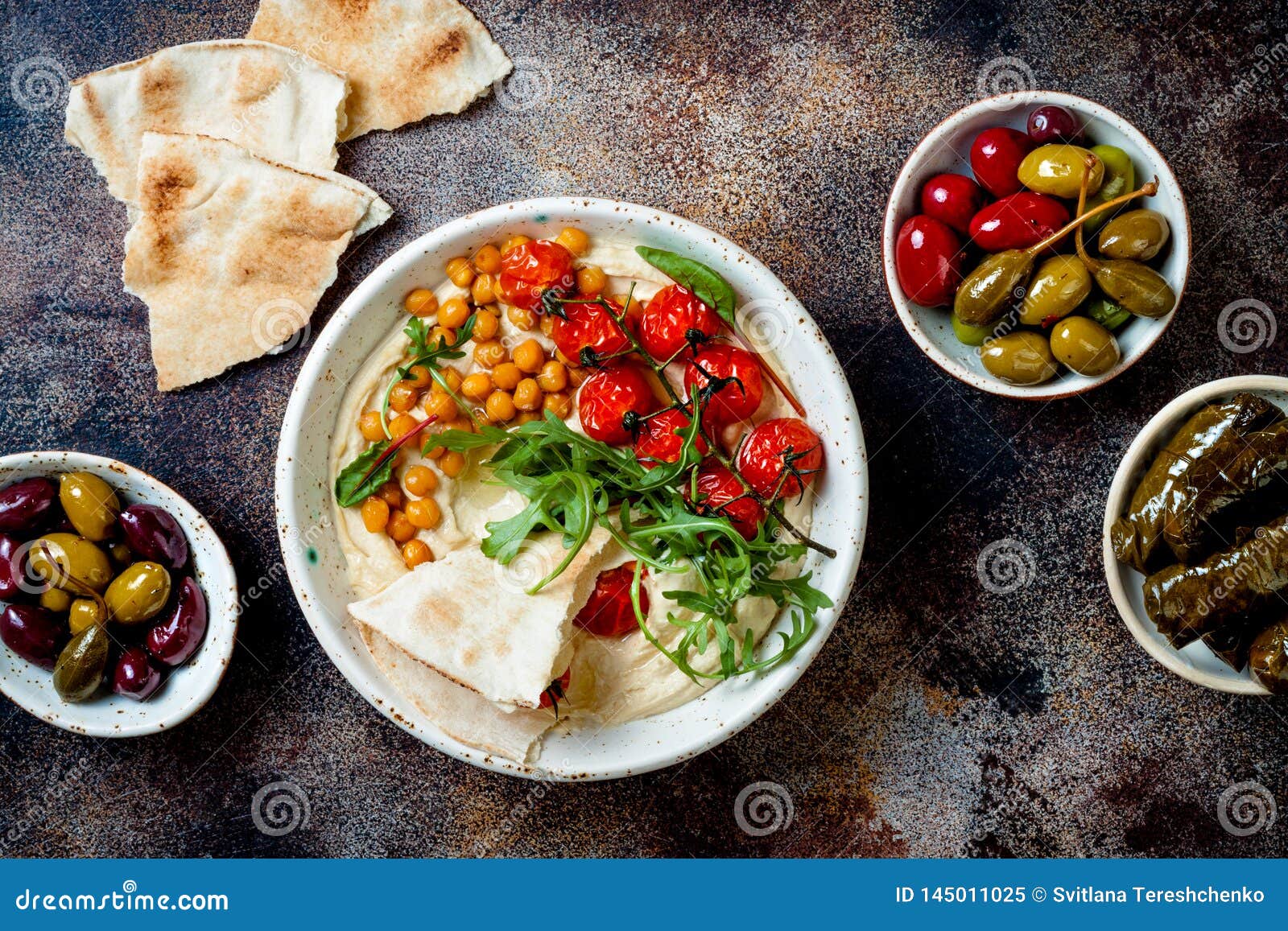 Homemade Hummus with Roasted Cherry Tomatoes, Olives, Dolma and Pita