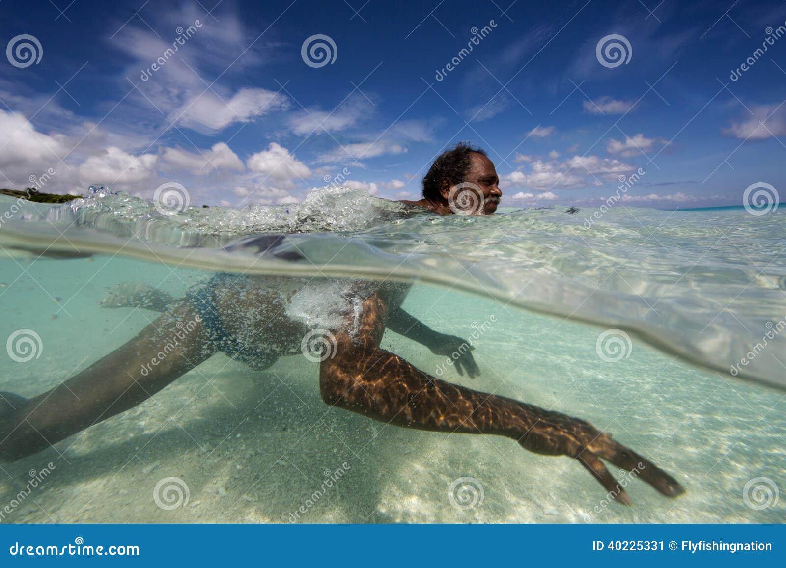 Indonesia Man on the way to his fishing boat. R r