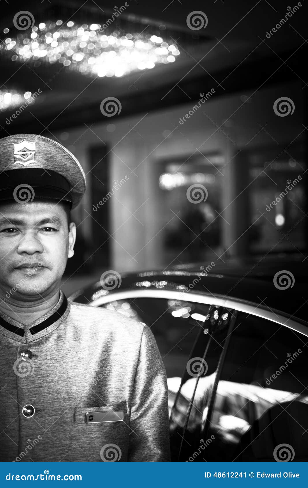 Parking attendant outside luxury 5 star GL hotel Bangkok Thailand. R r o