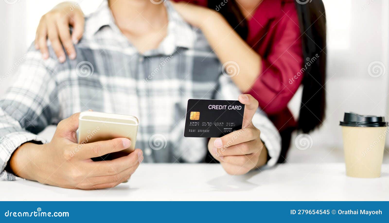 e-commerce concept. happy couple holding credit and using smartphone enter their card number in the mobile phone app to purchase