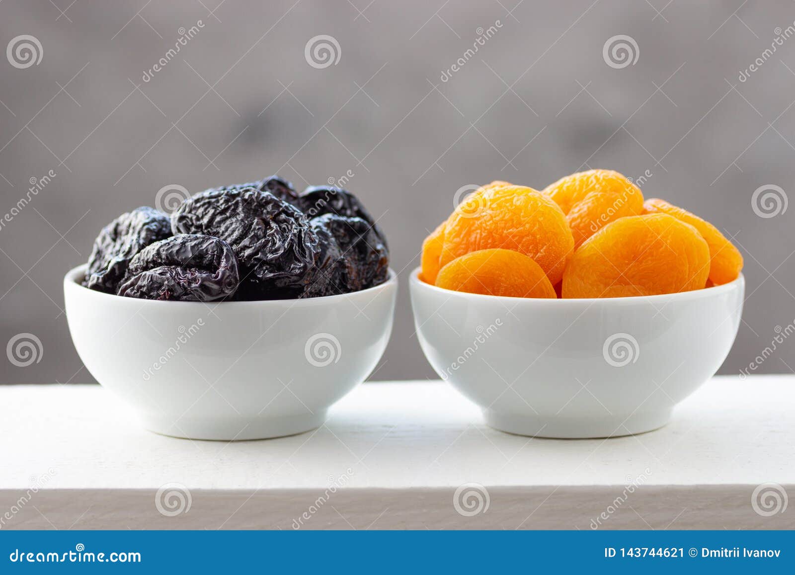 Prunes and Dried Apricots in White Bowls Imagen de archivo Imagen de