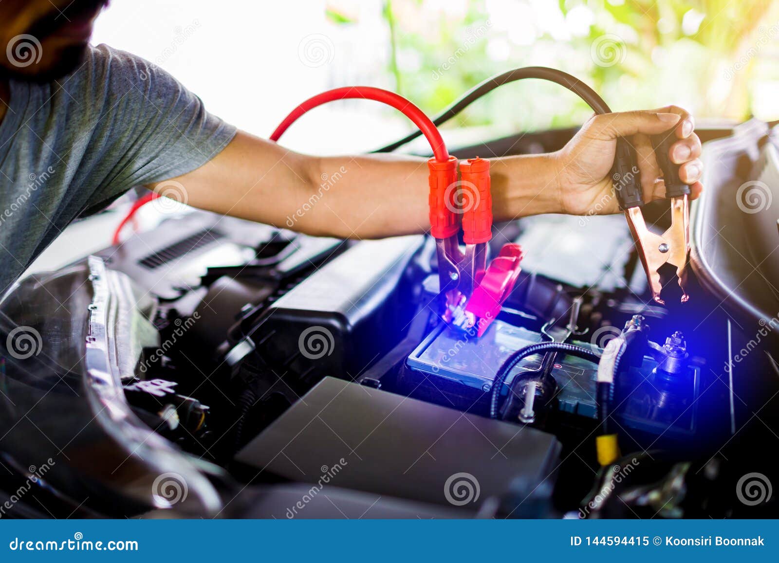 Selective Focus Hands Do Charging Car Battery with Electricity through
