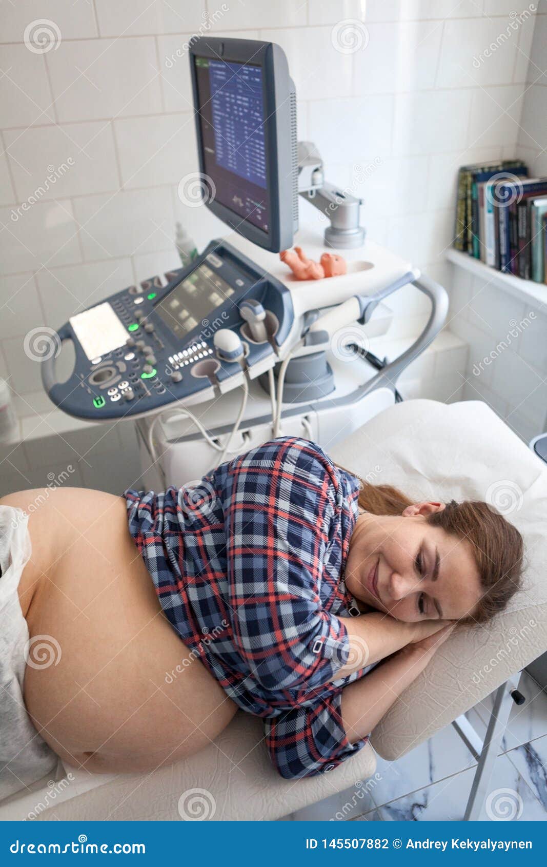 Happy Pregnant Woman Before Getting Ultrasound Scan From Obstetrician 