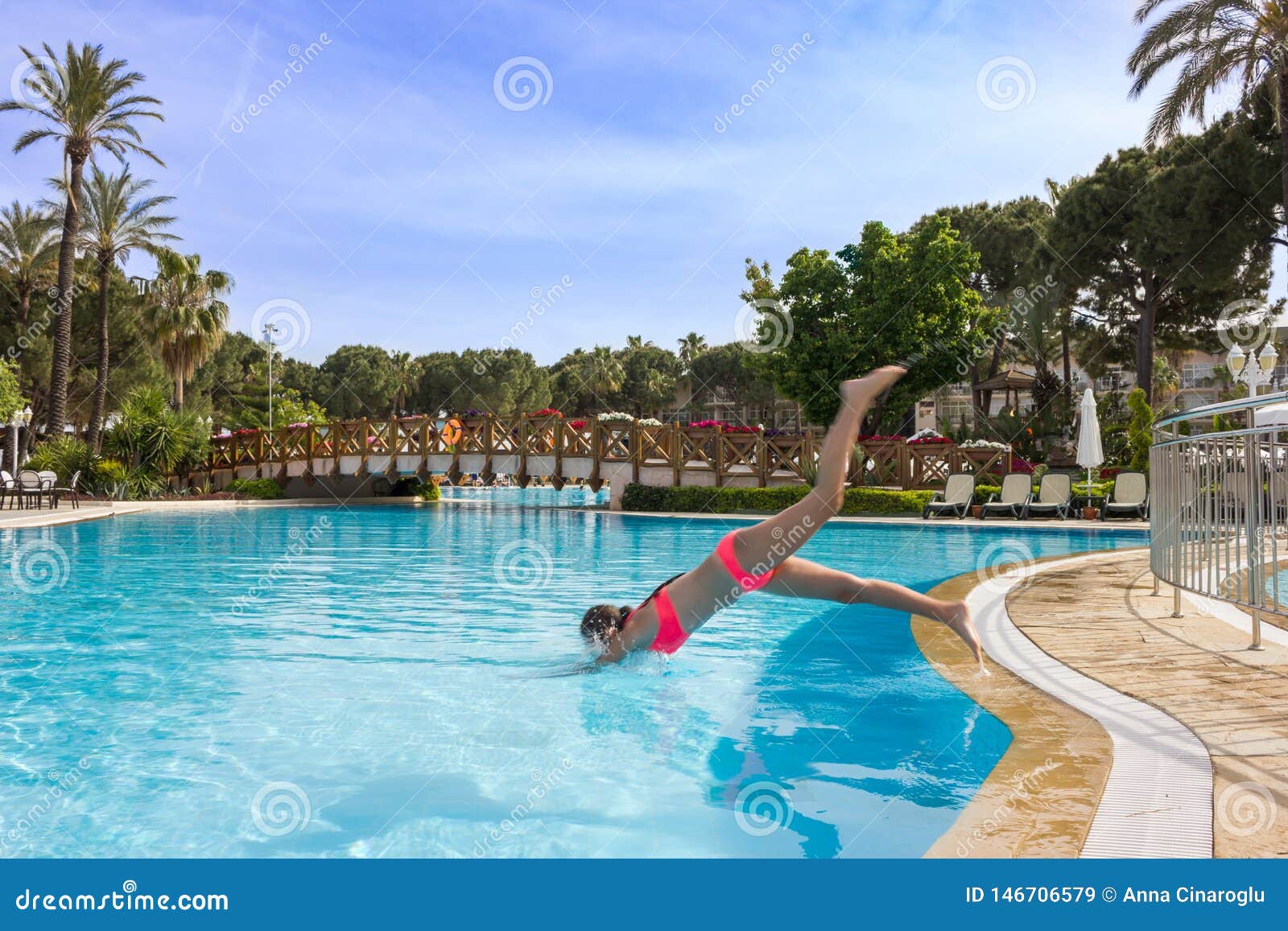 Young Teen Girl Swims And Have Fun In The Outdoor Pool