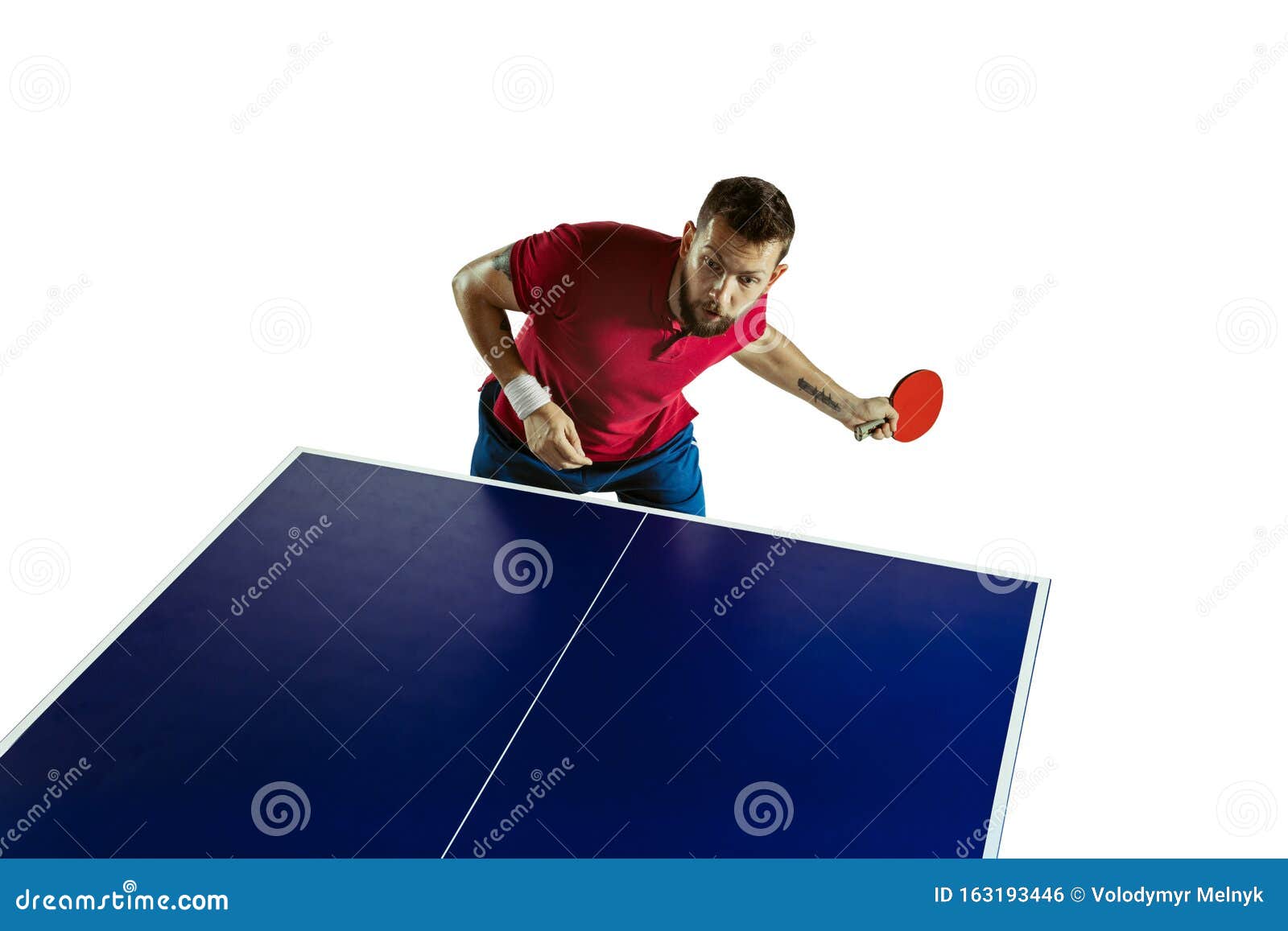 young man playing table tennis on white studio background