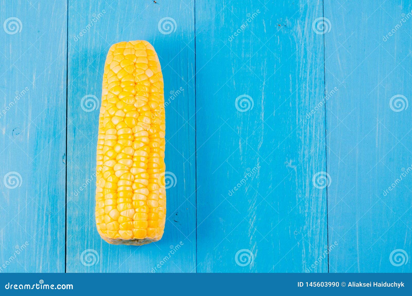 Ear of Boiled Appetizing Corn on a Blue Background/vegetarian Concept