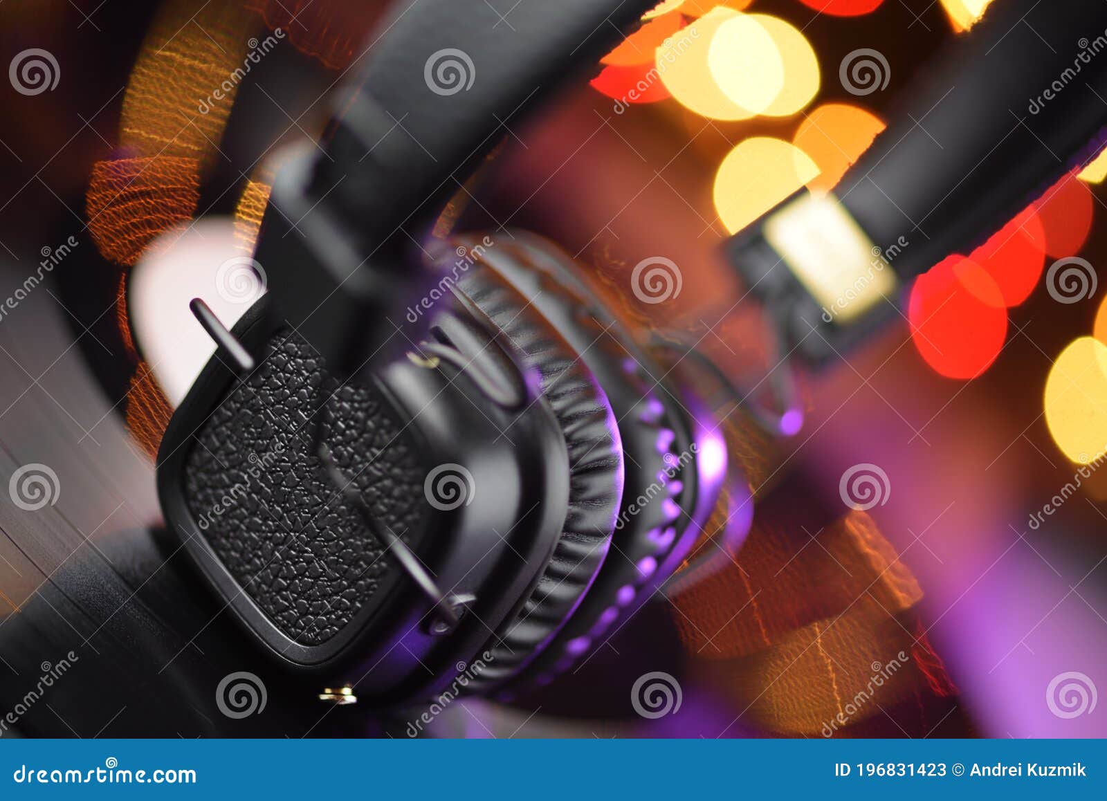Onear Headphones on Vinyl Record with Blured Lights Stock Image