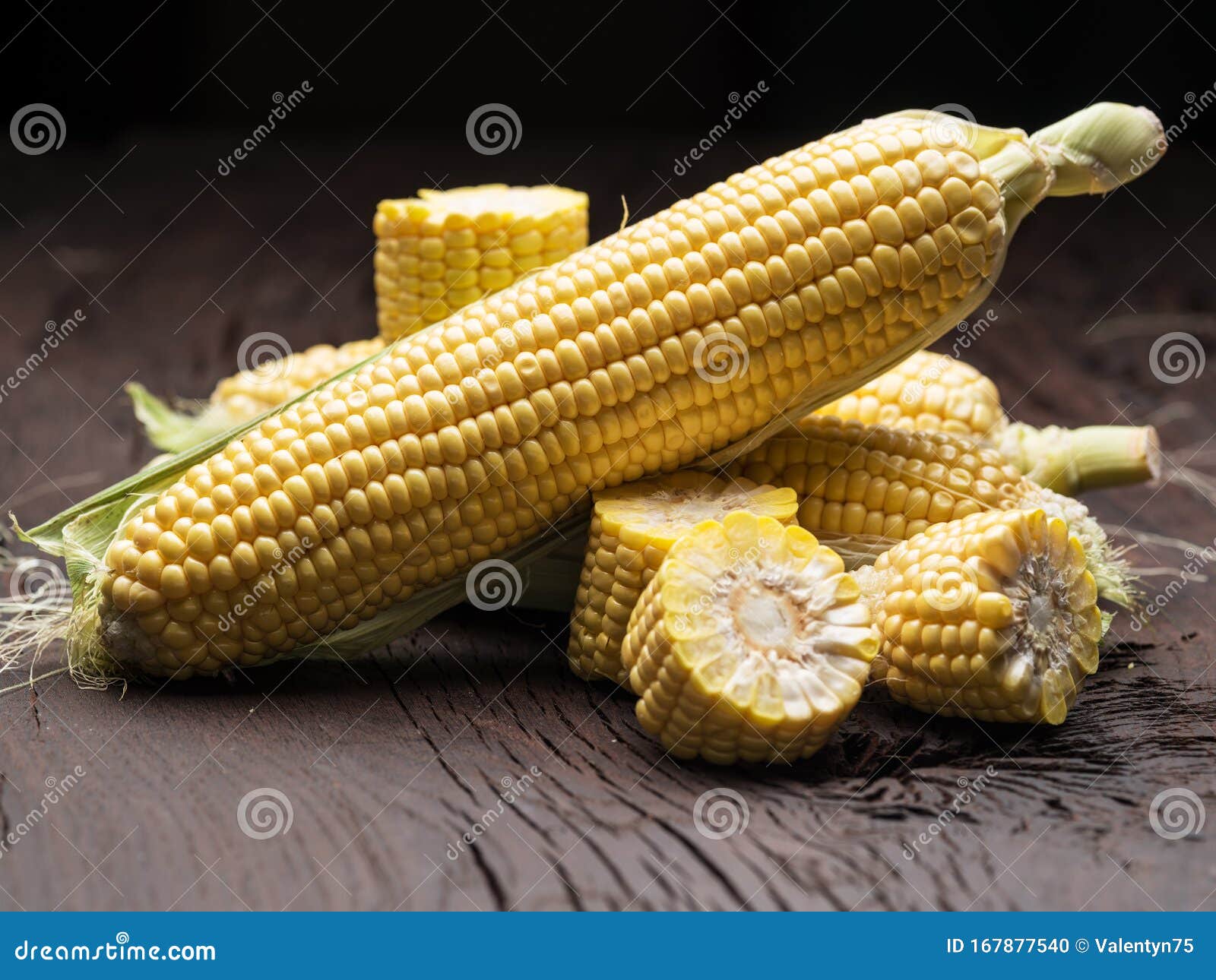 ear of maize or corn on the dark wooden background
