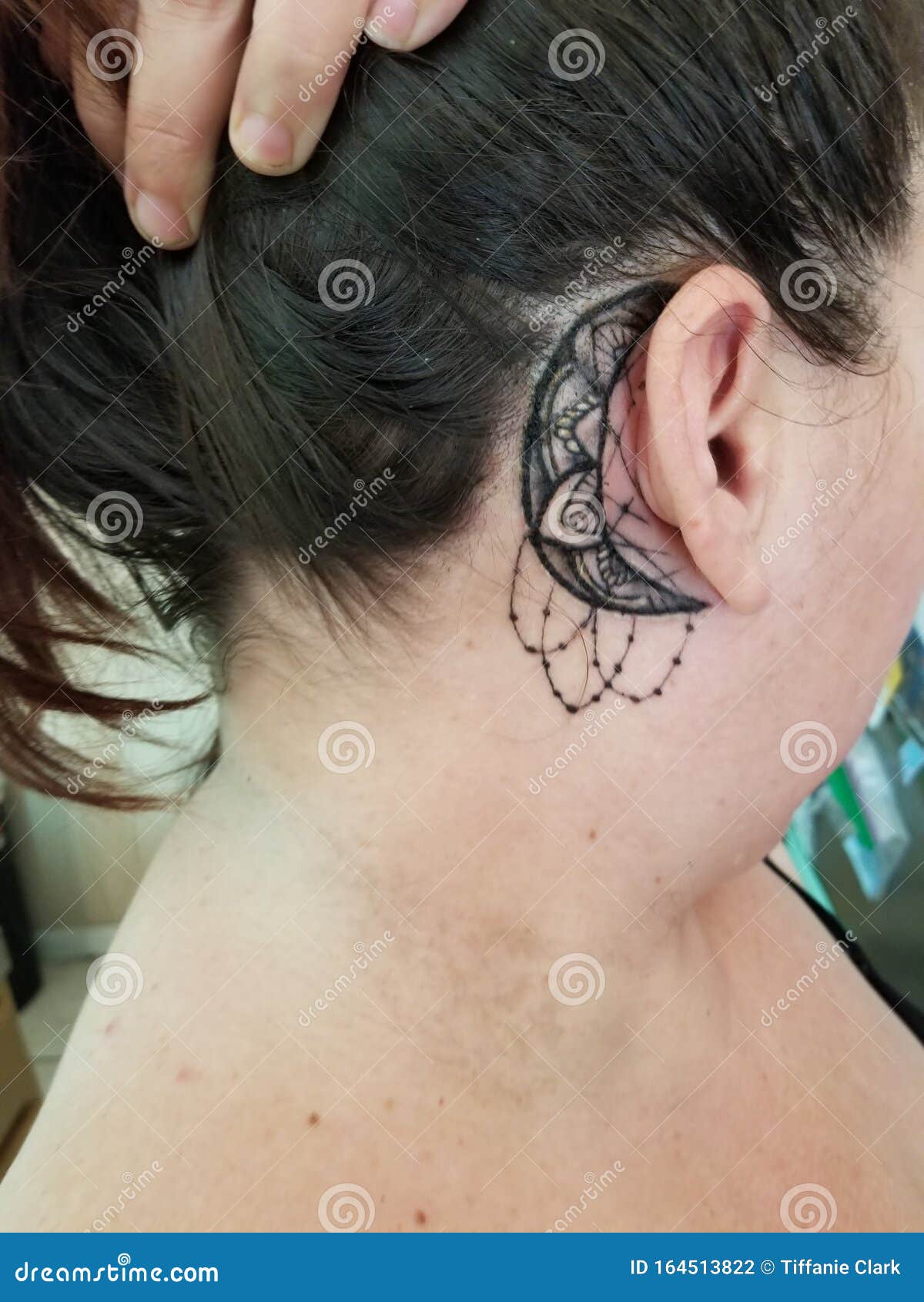 Crescent moon tattoo done behind the ear minimalistic