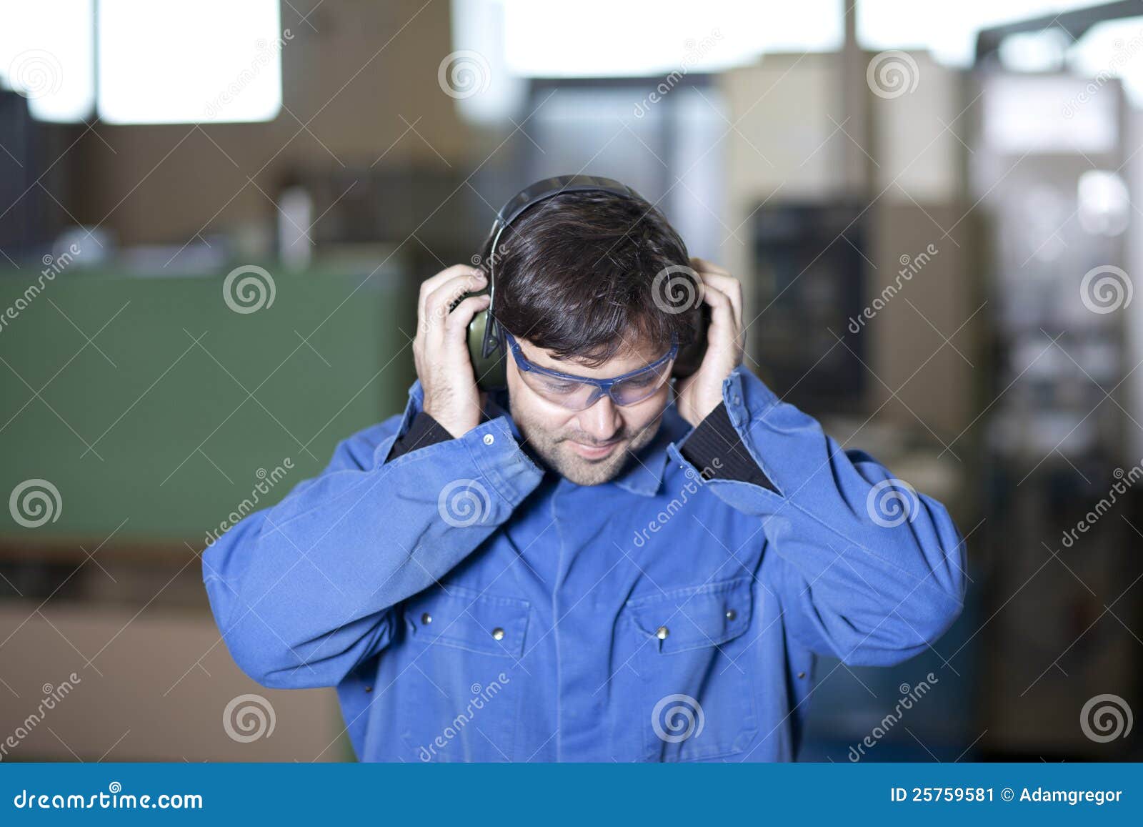 Ear protection at work stock image. Image of touching 25759581