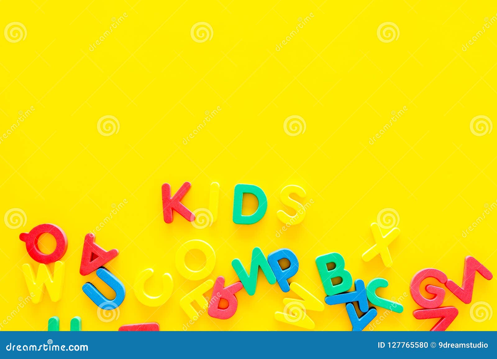 Early Childhood Development Concept Word Kids Written By Plastic Letters Of Toy Alphabet On Yellow Background Top View Stock Photo Image Of Education Child 127765580