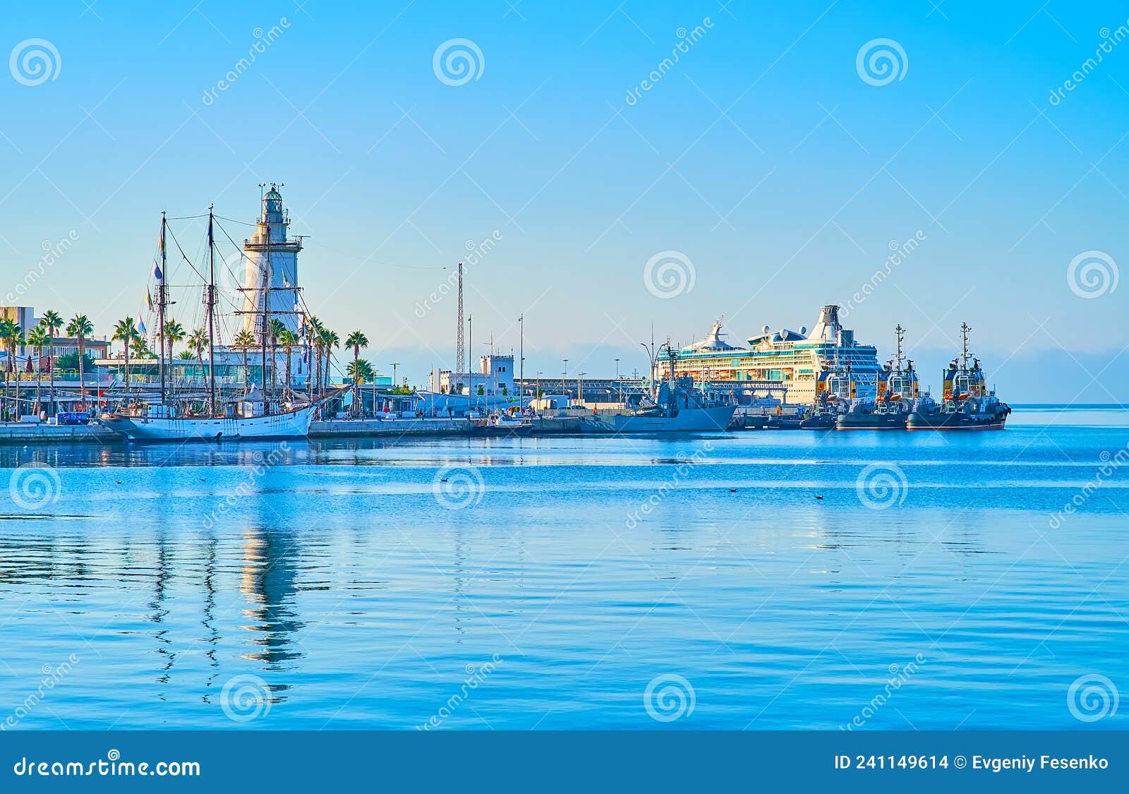 la farola lighthouse, yachts and ships in malaga port, spain