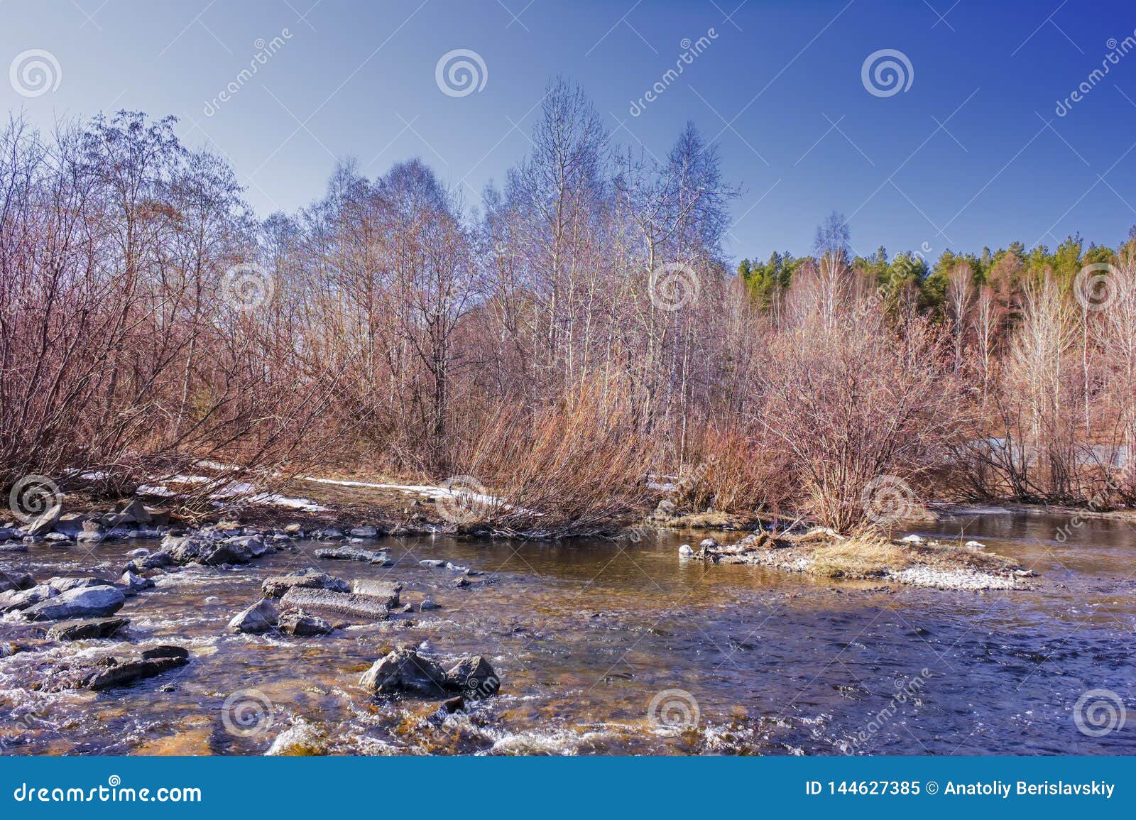 Early Spring Landscape Melts Ice on a Small River at the Edge of the