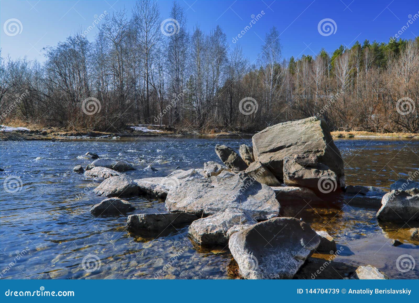 Early Spring Landscape Melts Ice on a Small River at the Edge of the