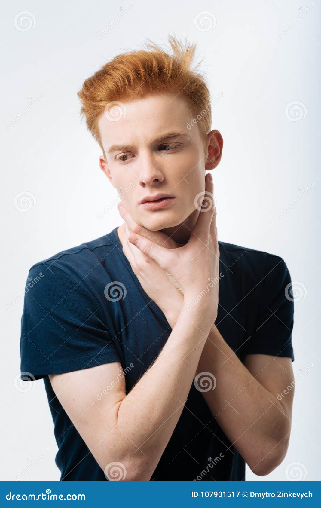 earnest red-haired man looking down