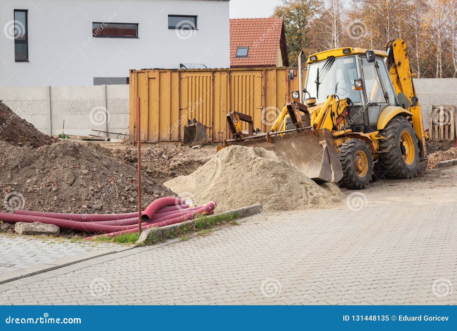 earth excavation works by excavator at the construction of a house