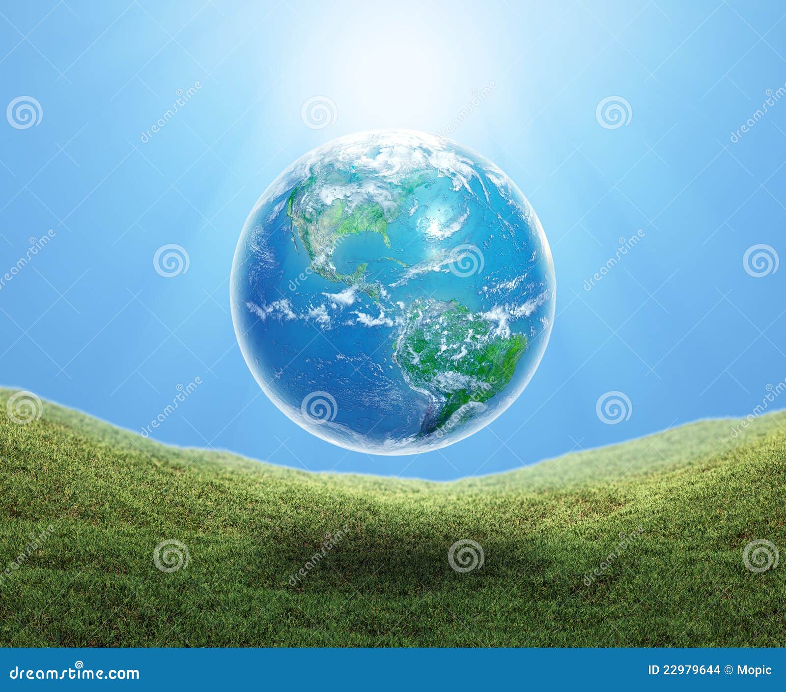 Earth floating over grass stock photo. Image of care 22979644