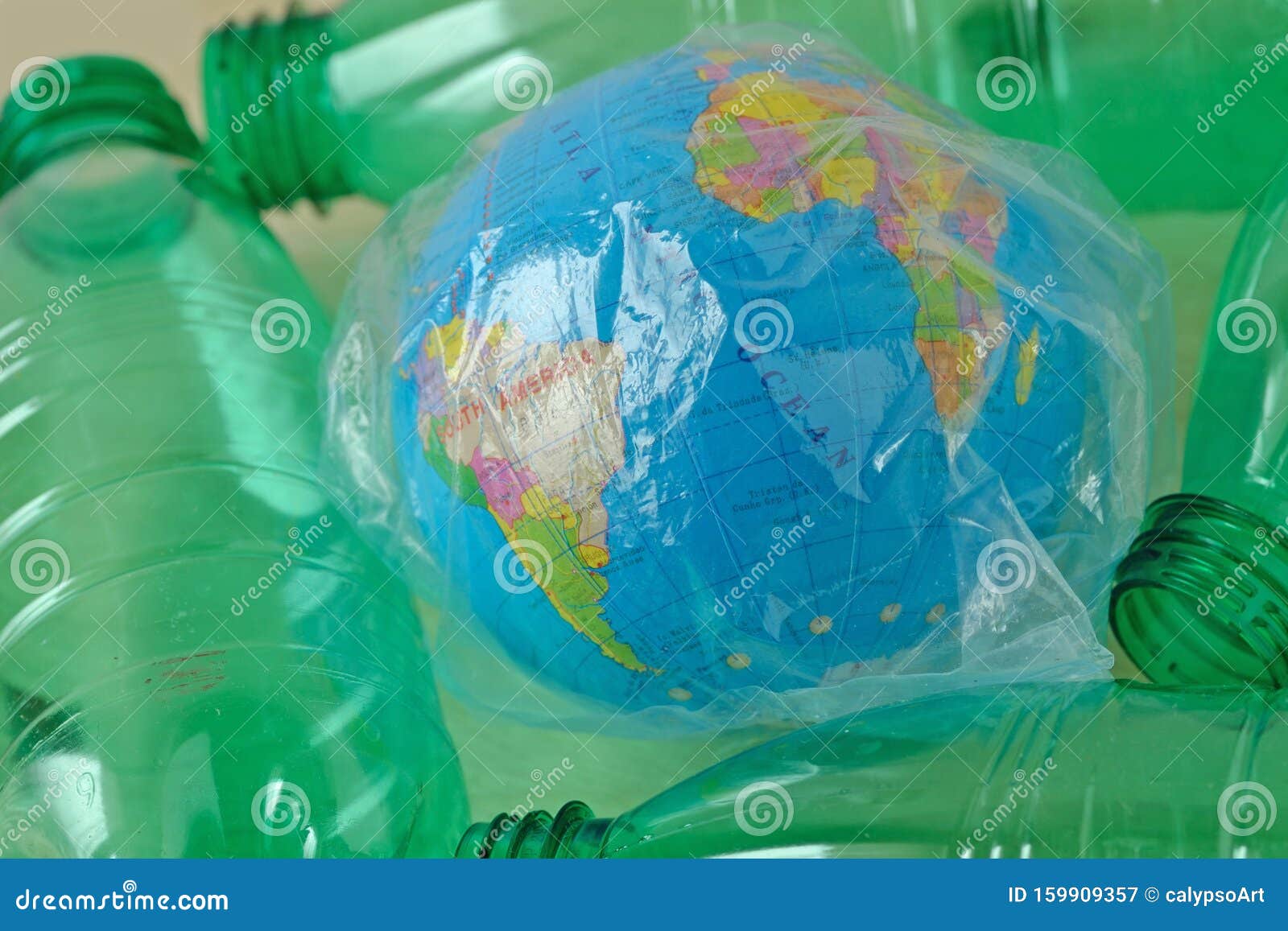 Earth Globe in Plastic Bag among Plastic Bottles Concept of Ecology and Stop Plastic Pollution