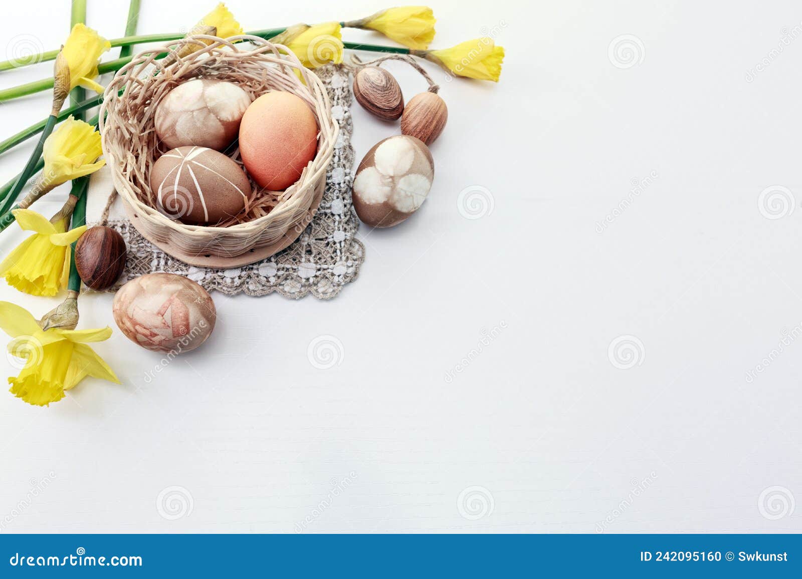 Easter Background with Brown Eggs in Basket and Yellow Daffodils. Stock
