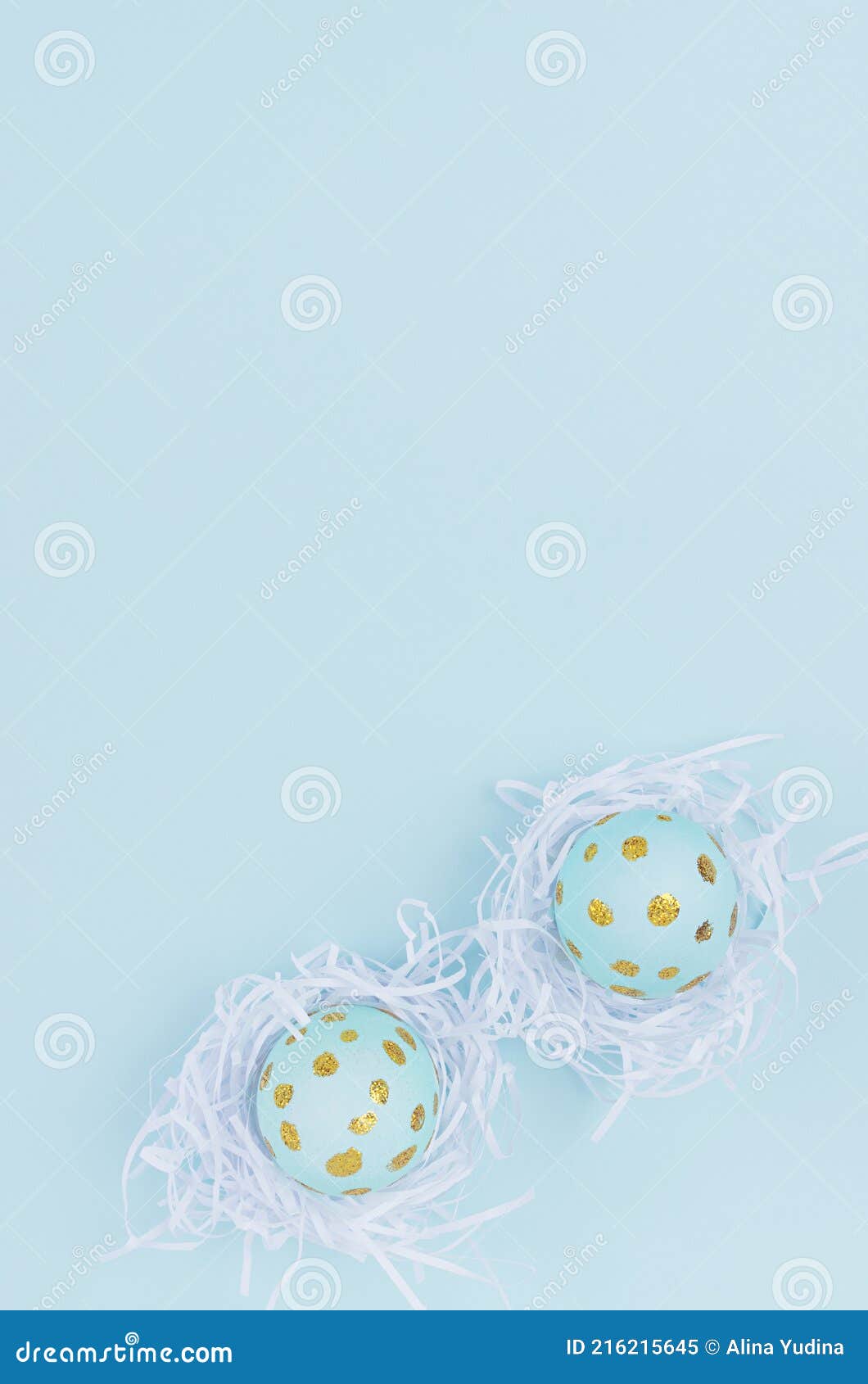 easter background - easter eggs with golden dots in white nest on blue backdrop, top view, vertical.