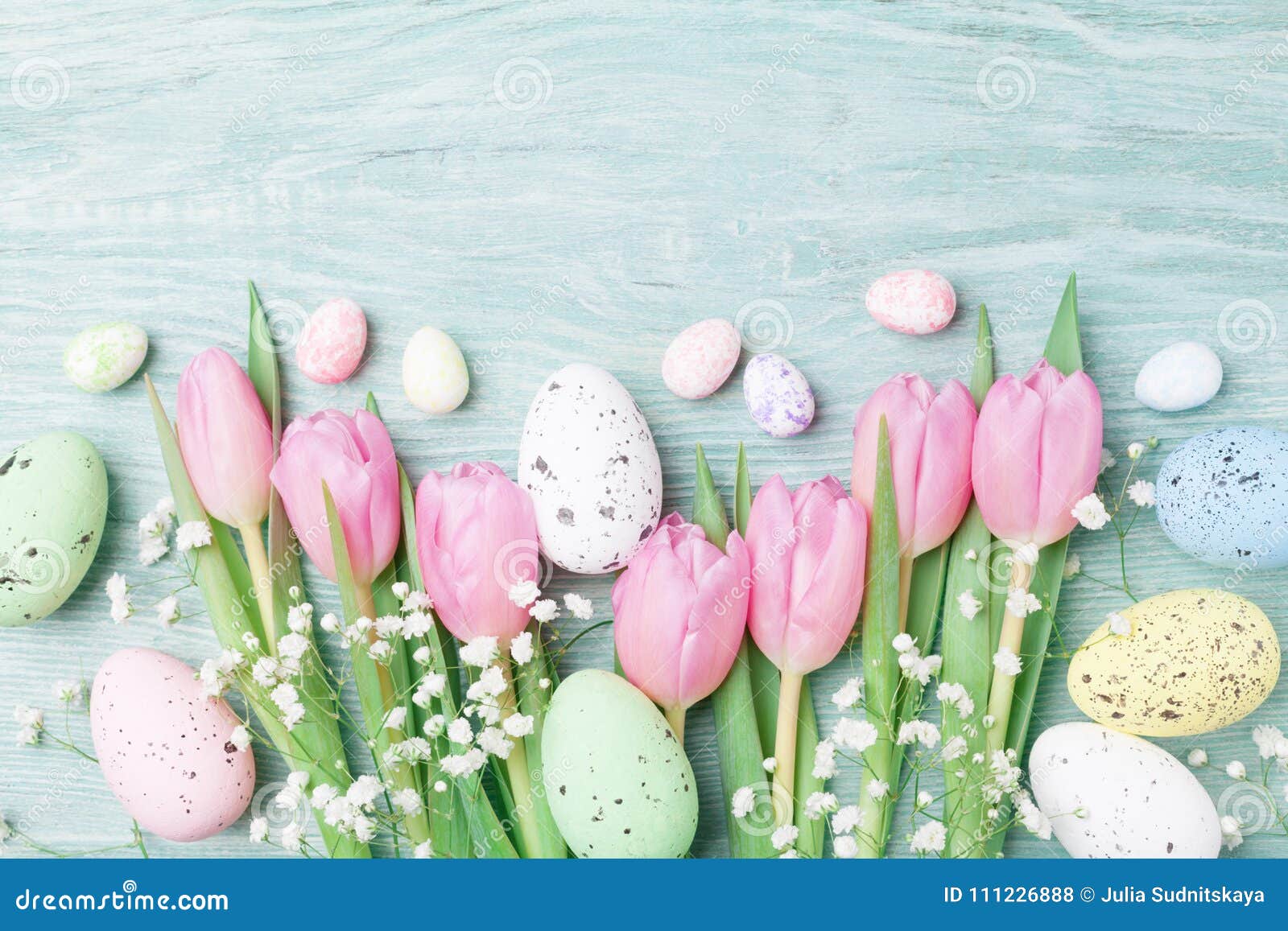 easter background from eggs and spring flowers. top view.