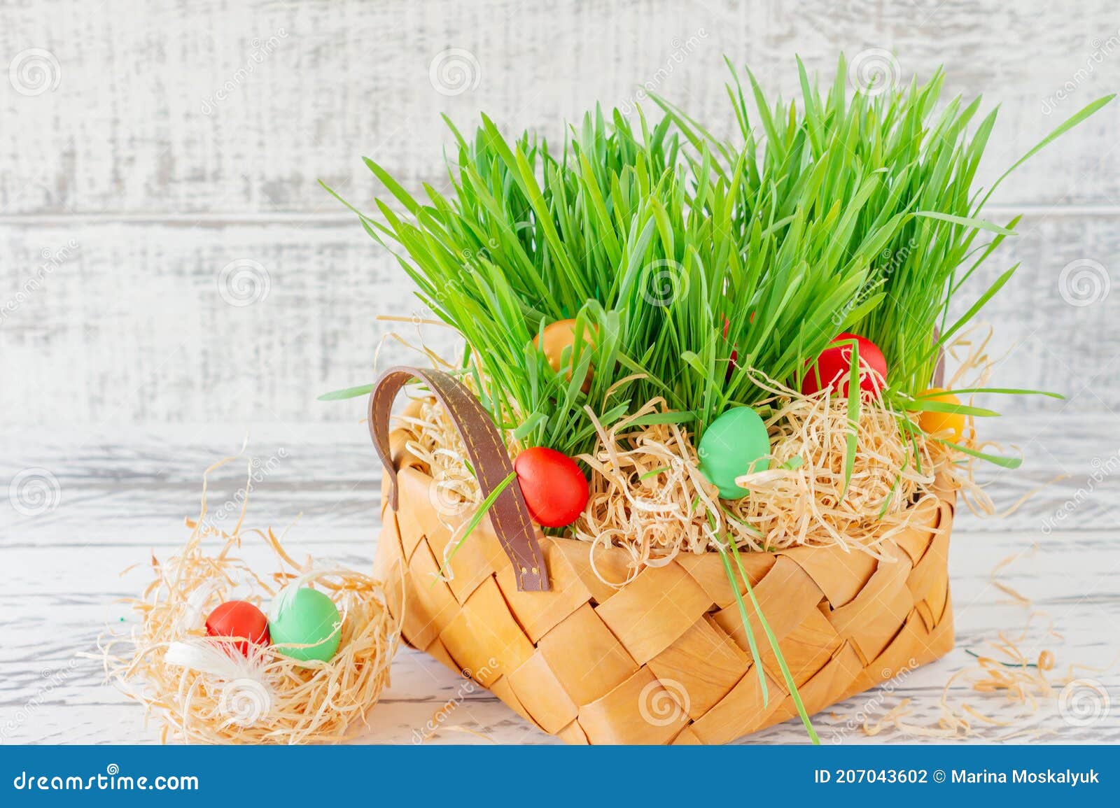 Easter Basket with Green Grass Filled with Brightly Colored Easter Eggs