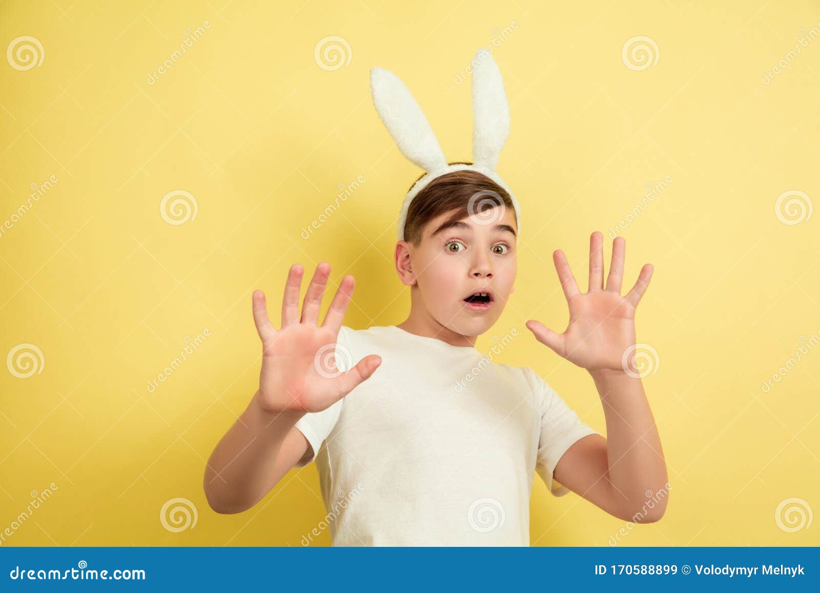 Easter Bunny Boy with Bright Emotions on Yellow Studio Background Stock ...