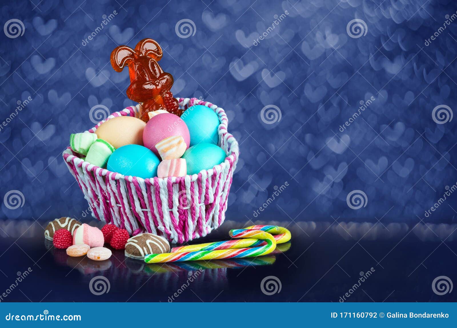 Easter Caramel Rabbit and Eggs in a Basket, on a Bokeh Background Stock