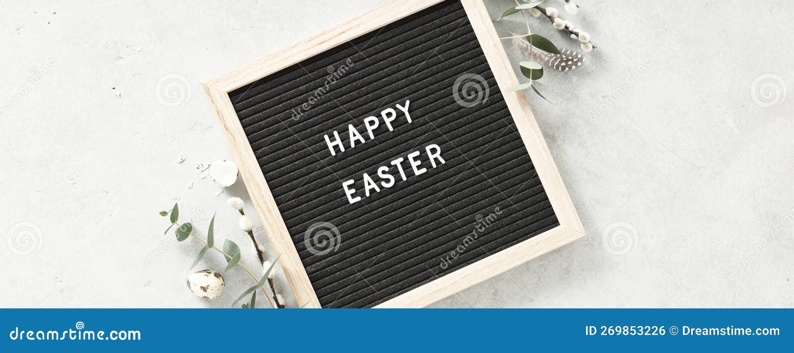 Easter Composition with Letter Board, Easter Eggs, Feathers and Eucalyptus on Grey Background