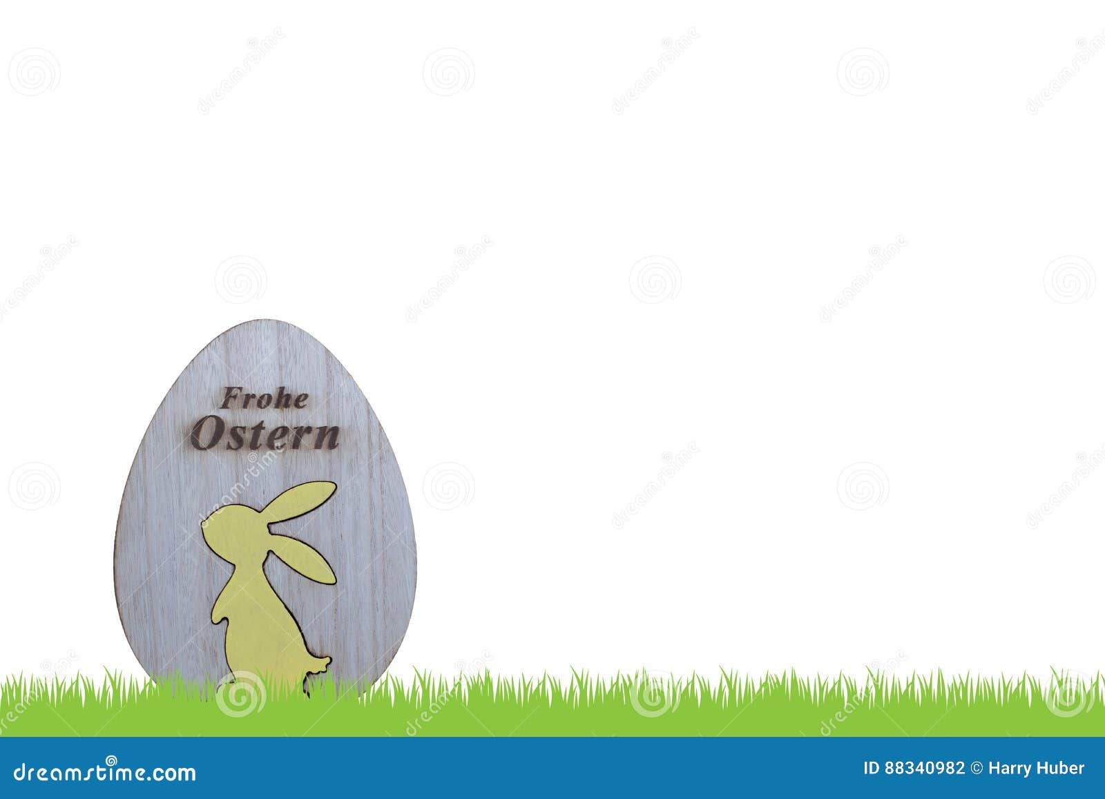 Easter, easter card. Grass and wooden egg with bunny and german text for happy easter