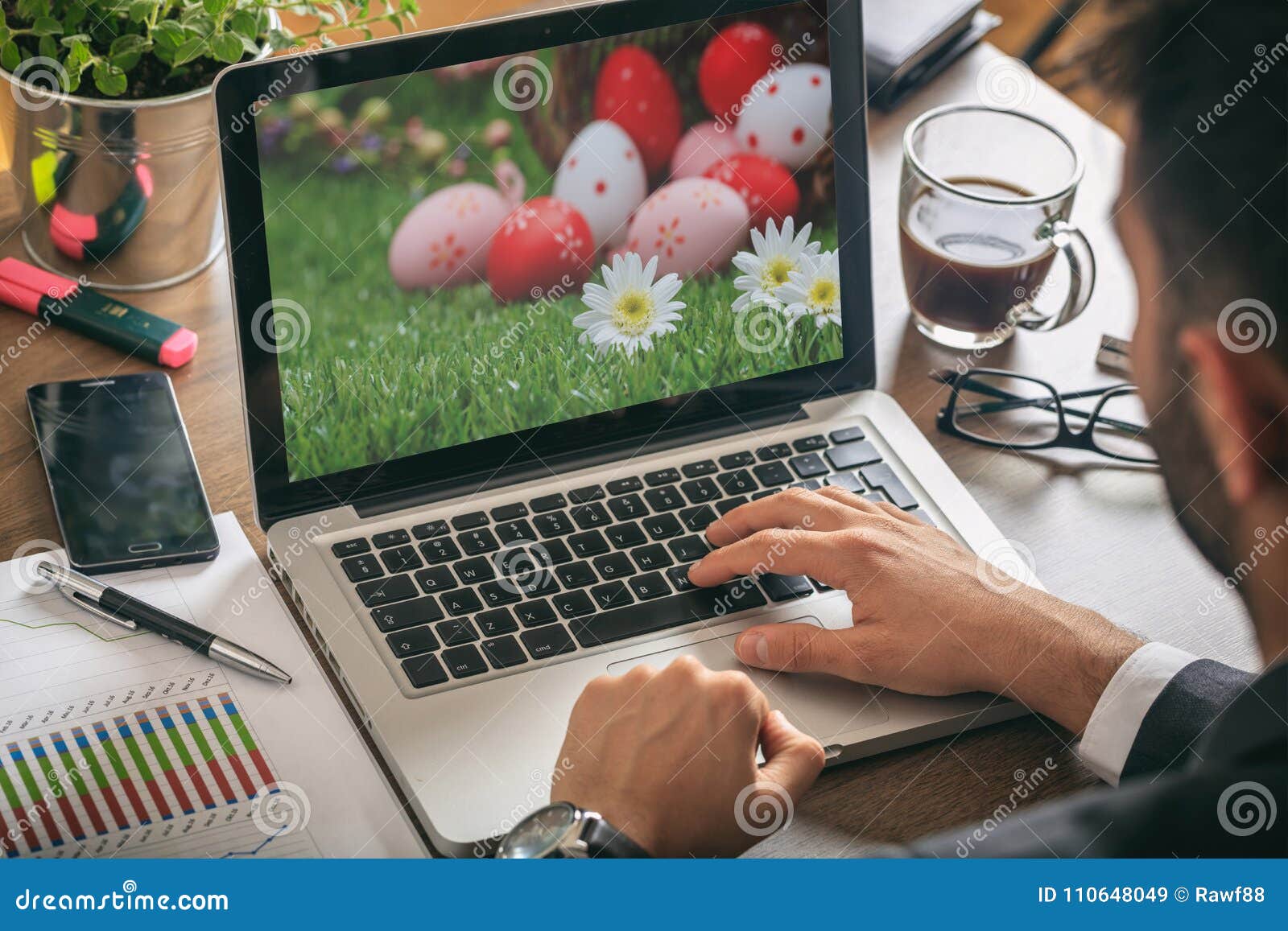Easter Eggs on a Computer Screen. Man Working in His Office Stock