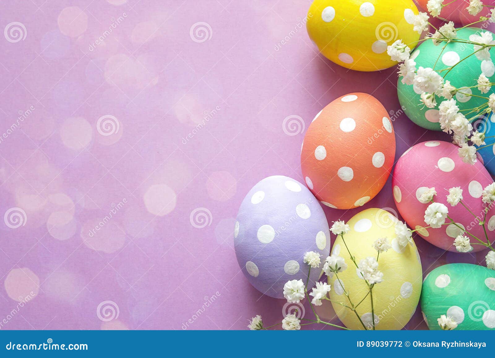 Easter Eggs and White Flowers on Purple Background. Space for Te Stock