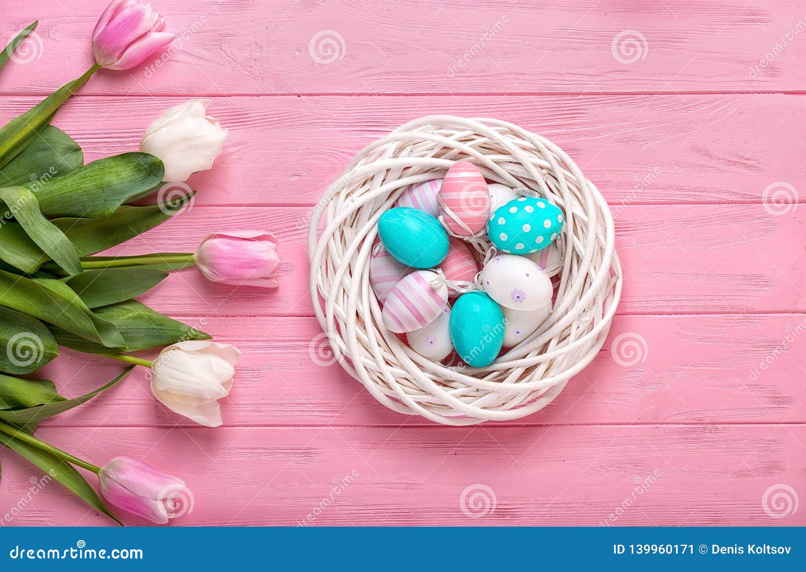 Easter Eggs in a Wicker Basket and Bouquet Tulips on Wooden Background ...