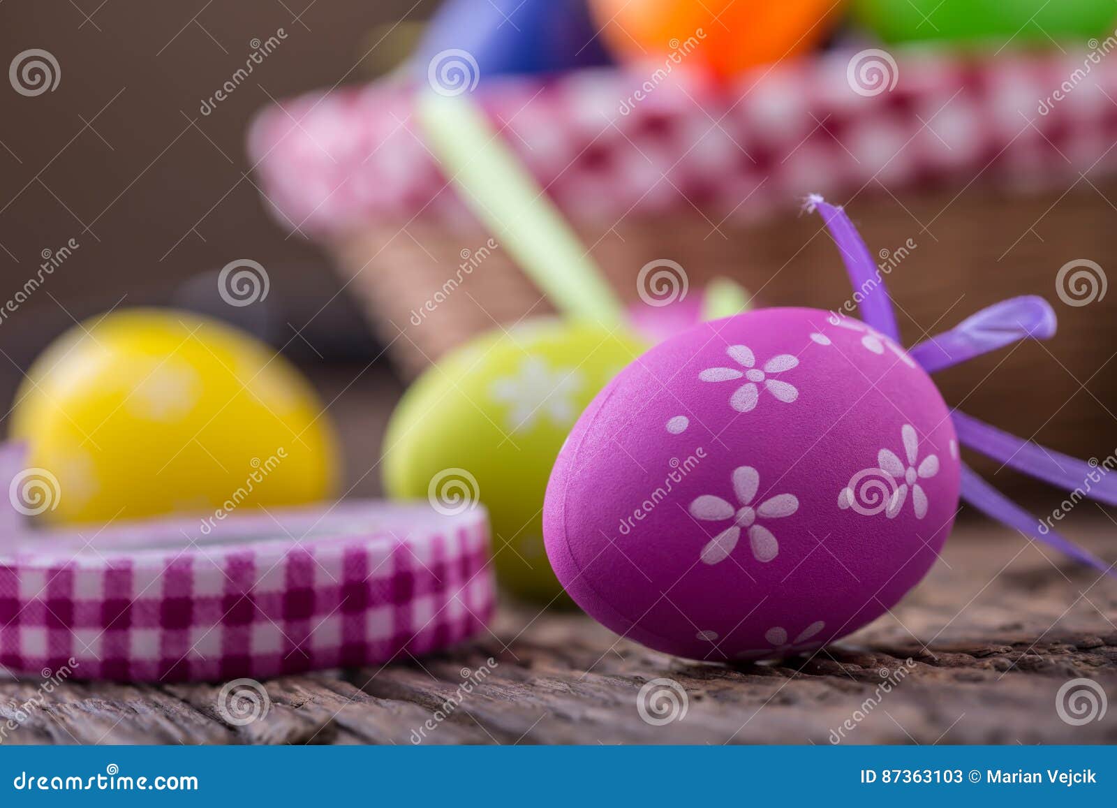 Easter. Multicolored Easter Eggs in a Basket on a Wooden Table Stock