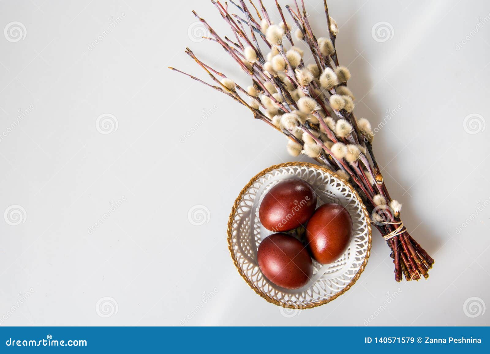 Easter Painted Brown Eggs and Willow on a White Background Stock Image