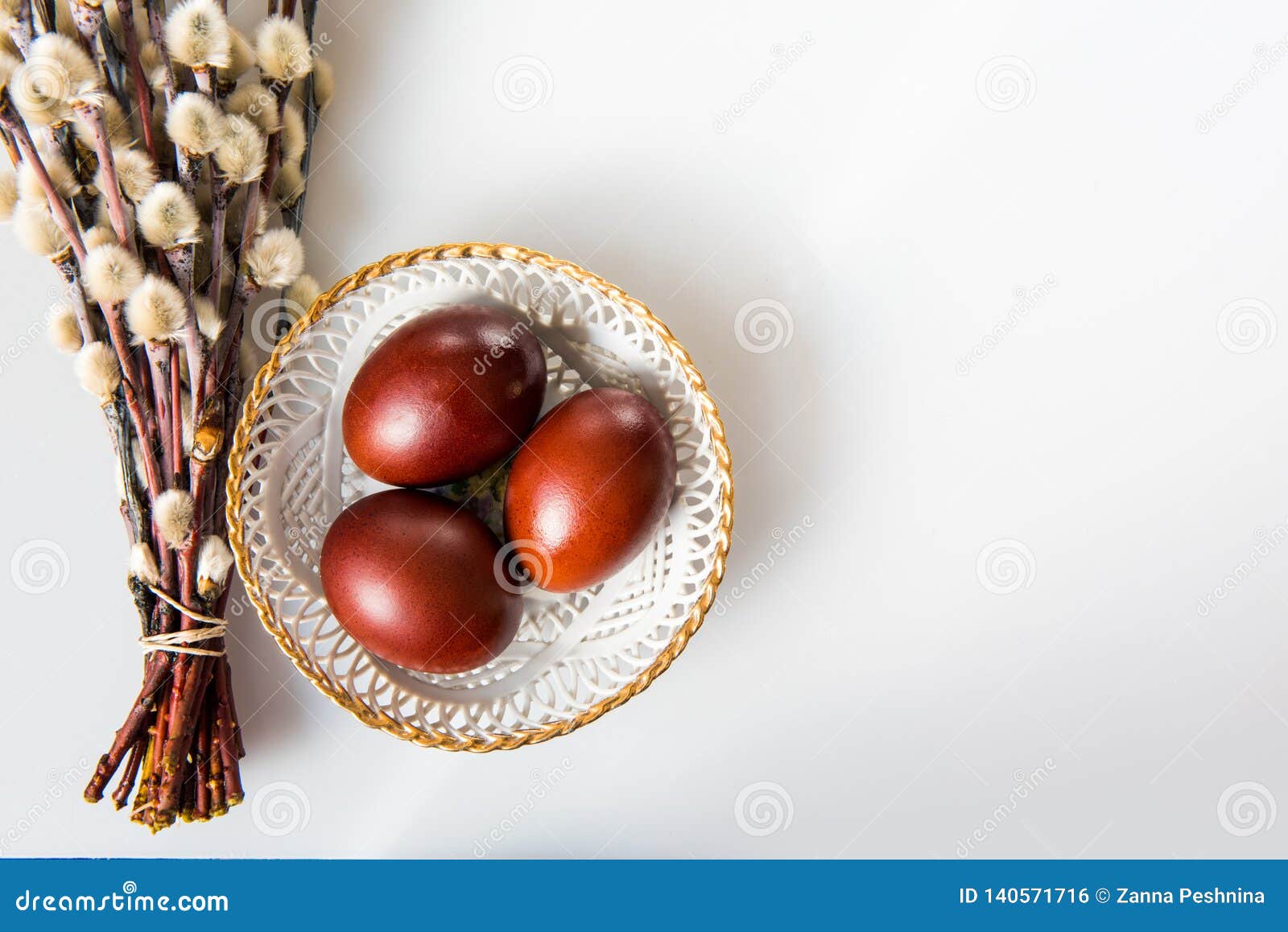 Easter Painted Brown Eggs and Willow on a White Background Stock Photo