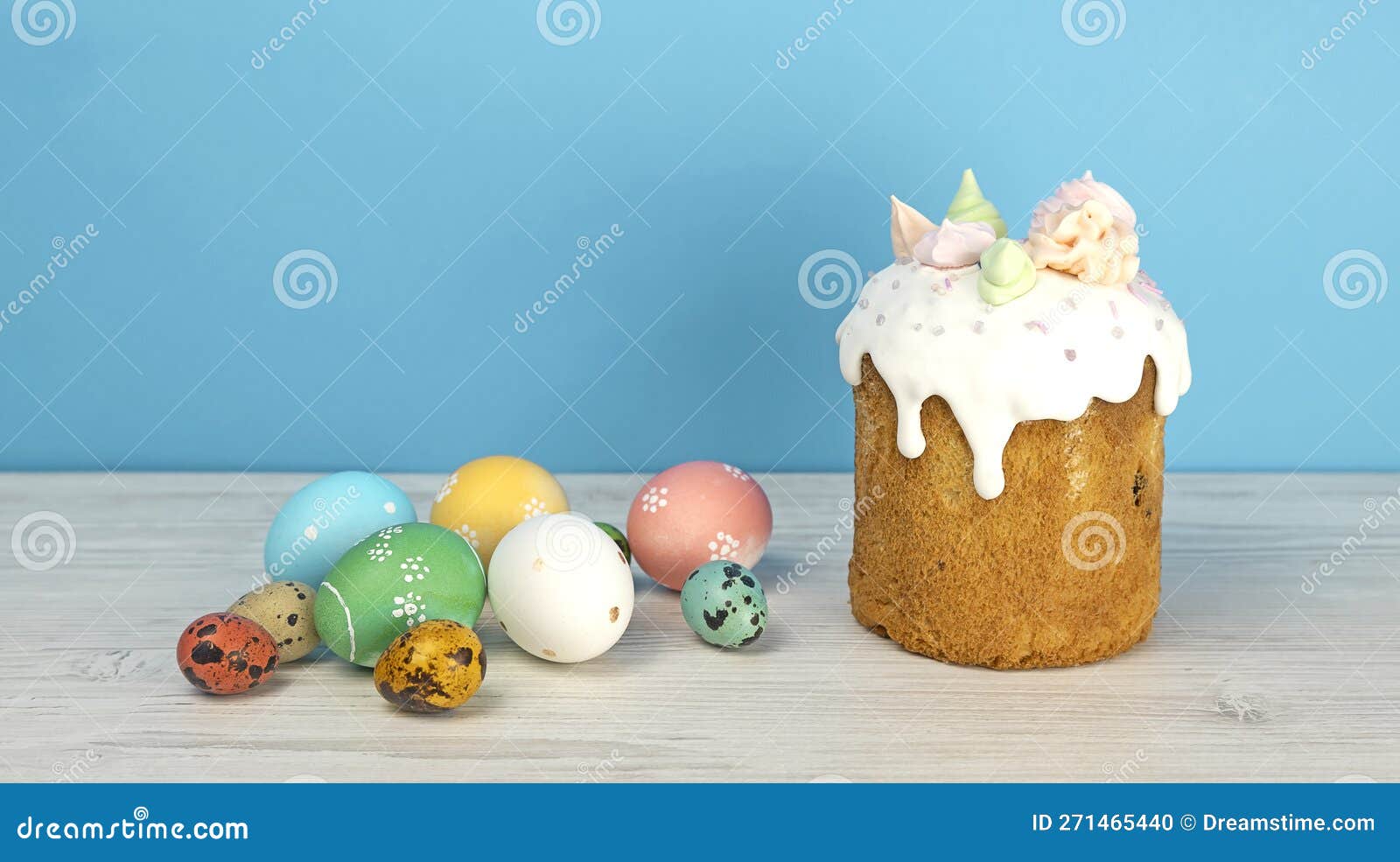 Easter Pastries and Colored Eggs on a Blue Background. Glazed Easter