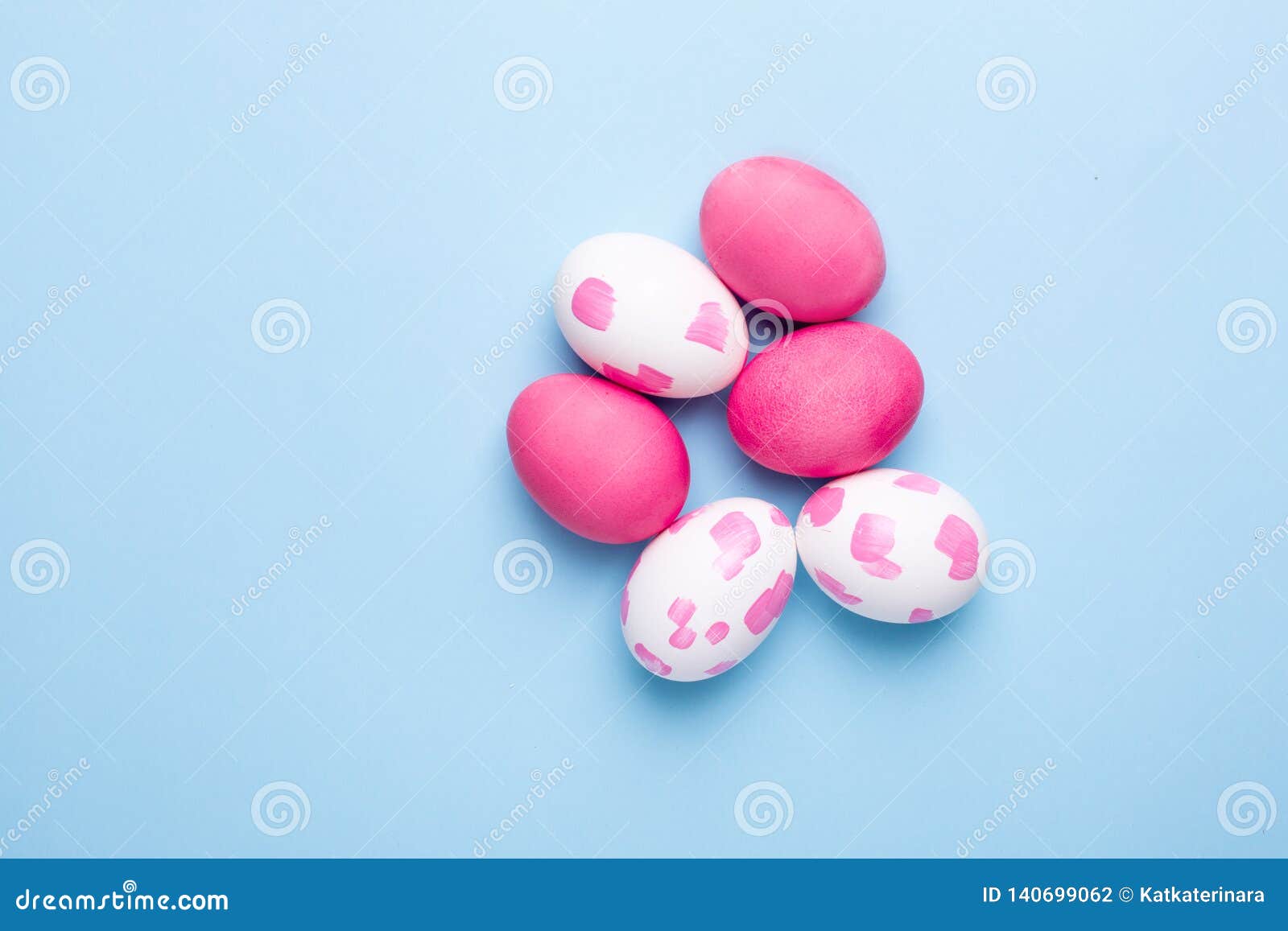 Easter Pink Eggs with Watercolor Brushstrokes on a Blue Background