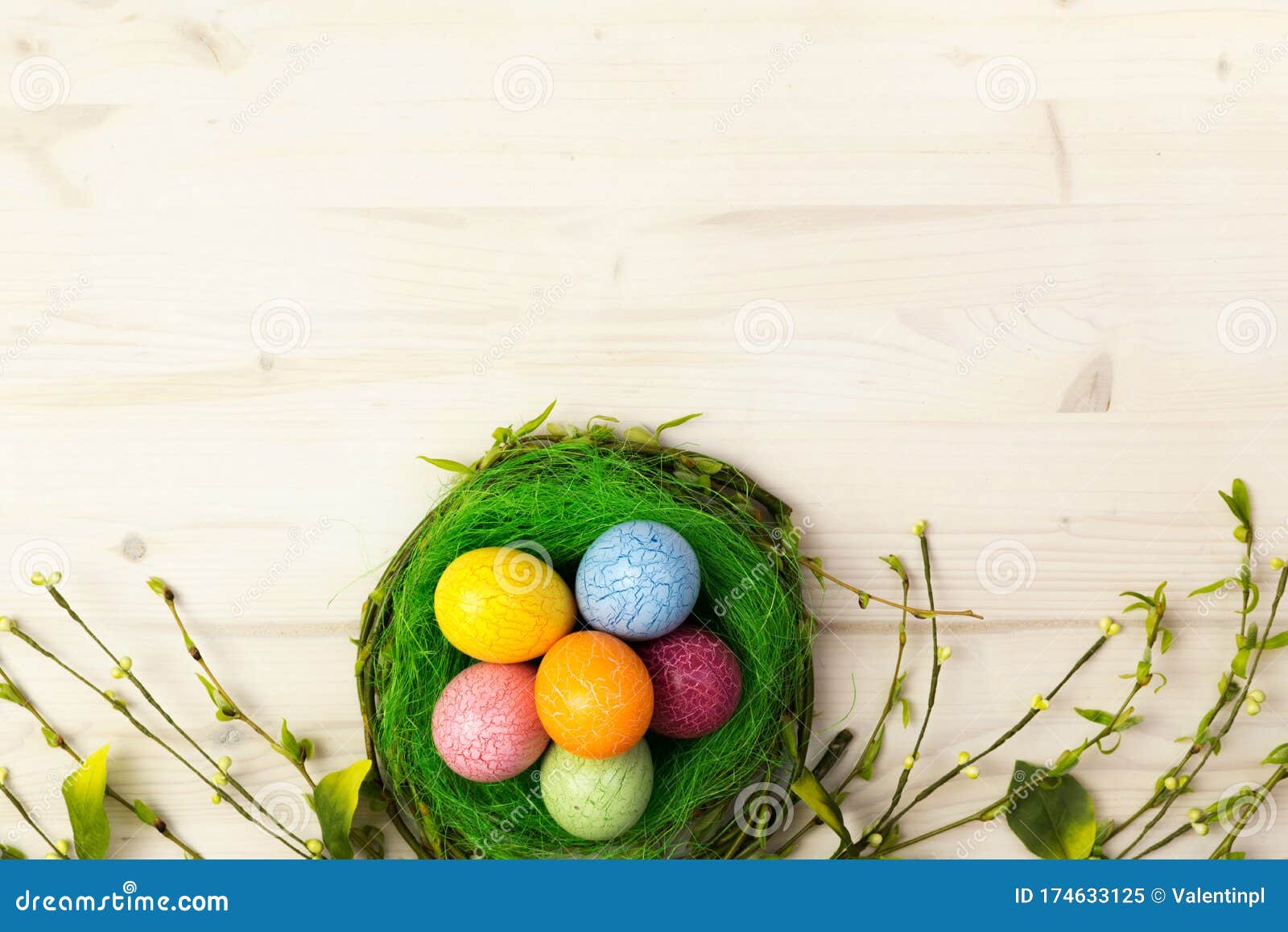 Easter Scene with Colorful Easter Eggs in Nest and Spring Willow