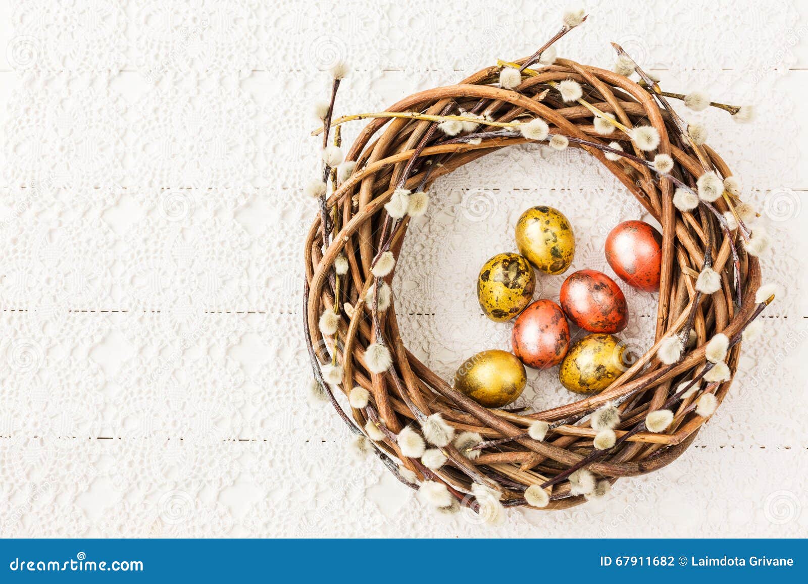 Easter Willow Wreath and Quail Easter Eggs on White Tablecloth. Top