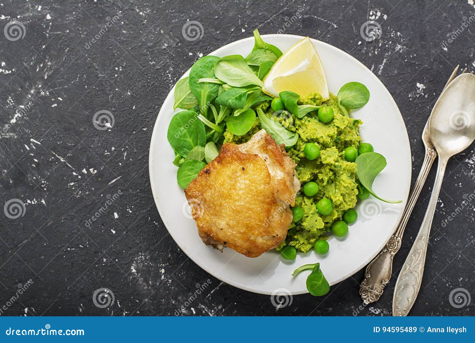 Easy Healthy Lunch Chicken Thigh with Mashed Green Peas and Corn Salad on a Light Background