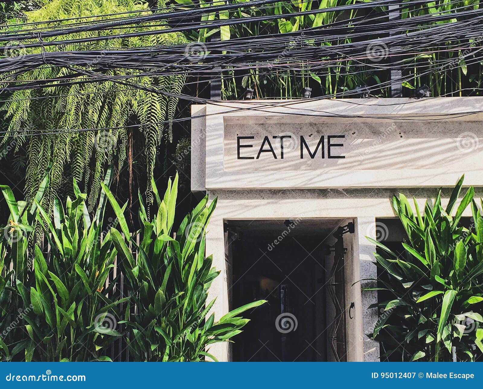 Eat Me Sign Front Gate Of Garden Style Cafe And Restaurant Stock