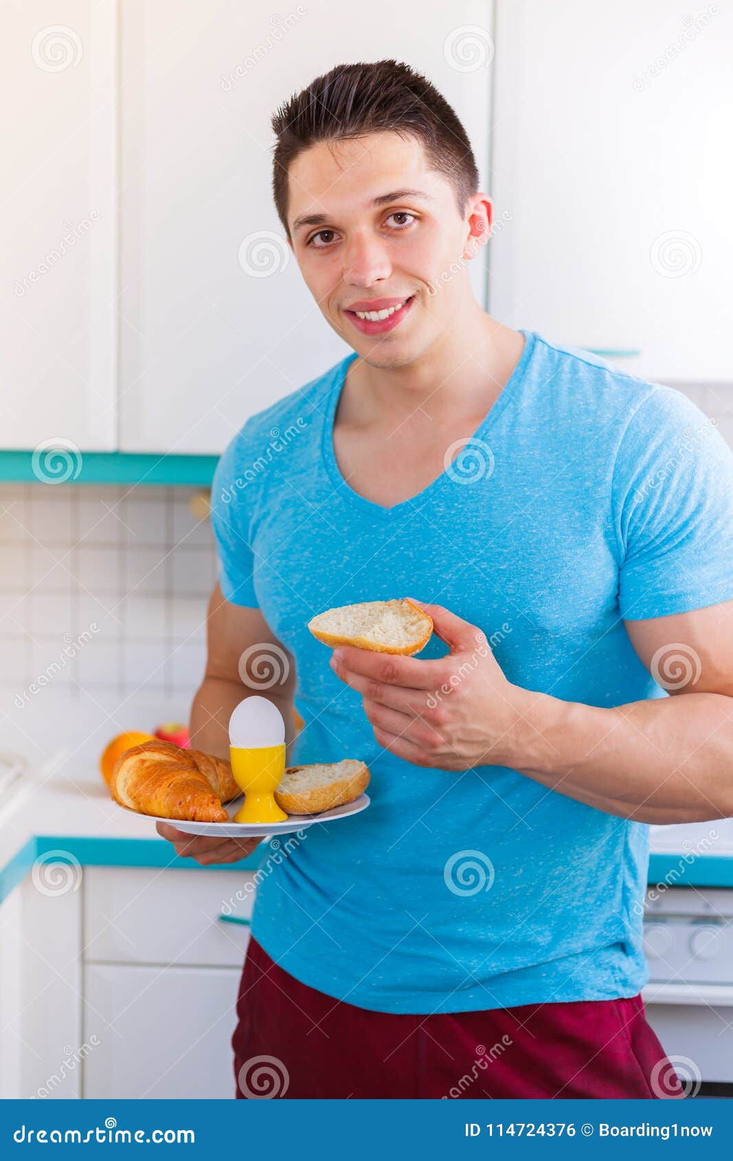 Eating Breakfast Young Man In The Kitchen Portrait Format Smiling