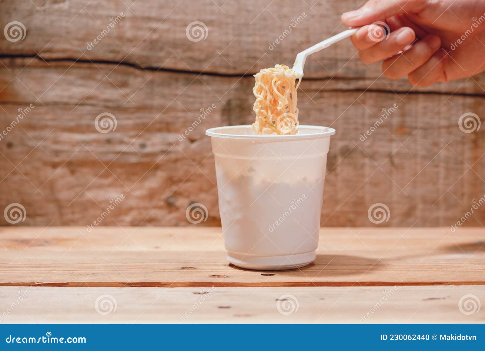 Eating Instant Noodles in Cup with a Fork. Junk Food Instant Noodles