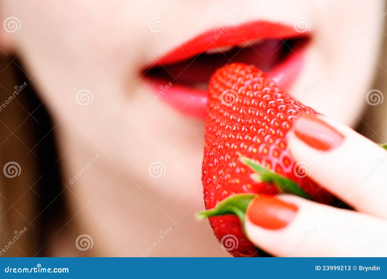 Eating a strawberry stock image. Image of face, closeup - 23999213